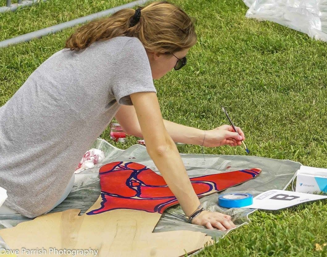 Me painting a wooden fish
